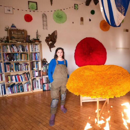 VCFA MFA in Visual Art alumnx Molly Gambardella in her home studio next to her lichen sculptures 