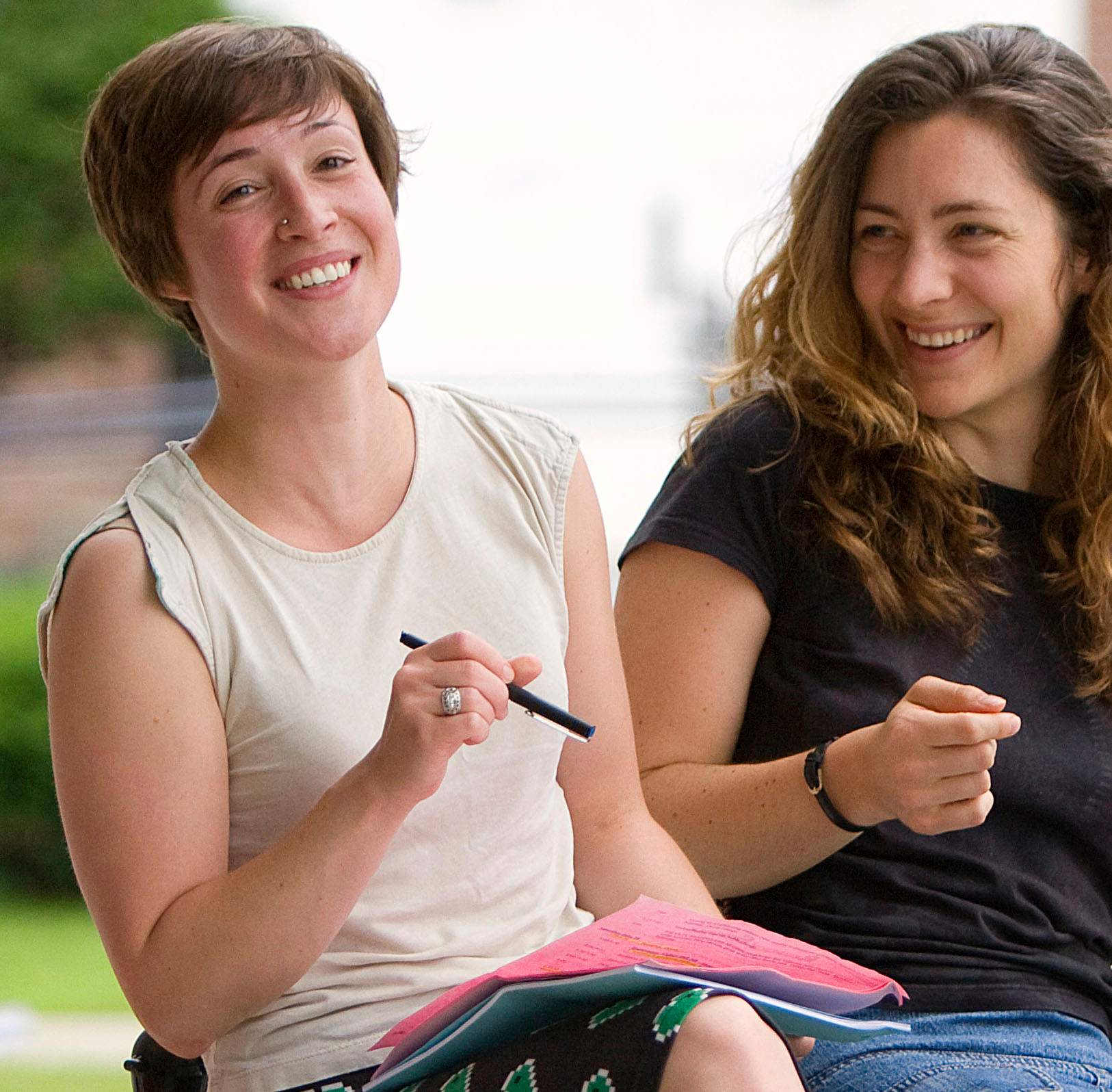 VCFA writing students smile and laugh while discussing how to write dialogue.