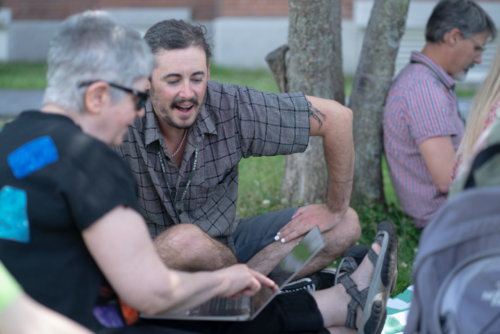 VCFA students discuss how to write a graphic novel while studying outside.