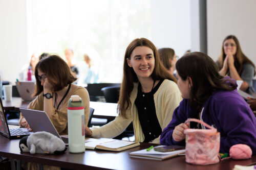 Students with the Writing for Children and Young Adults program discuss horror writing prompts.