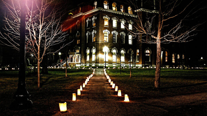 A photo of VCFA's College Hall illuminated with lights on a winter night