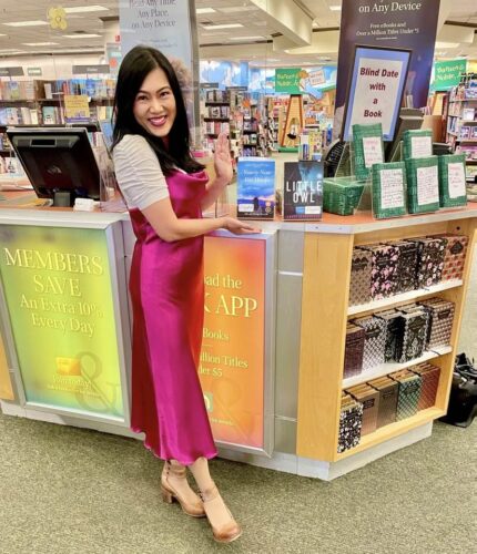 Allison Hong Merrill in a bookstore with Ninety-Nine Fire Hoops